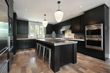 Kitchen with dark wood cabinetry and chrome fittings; we install similar kitchens throughout the Bury St Edmunds area