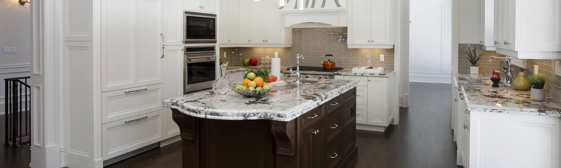 New kitchen with fitted units, central island and marble work-surfaces